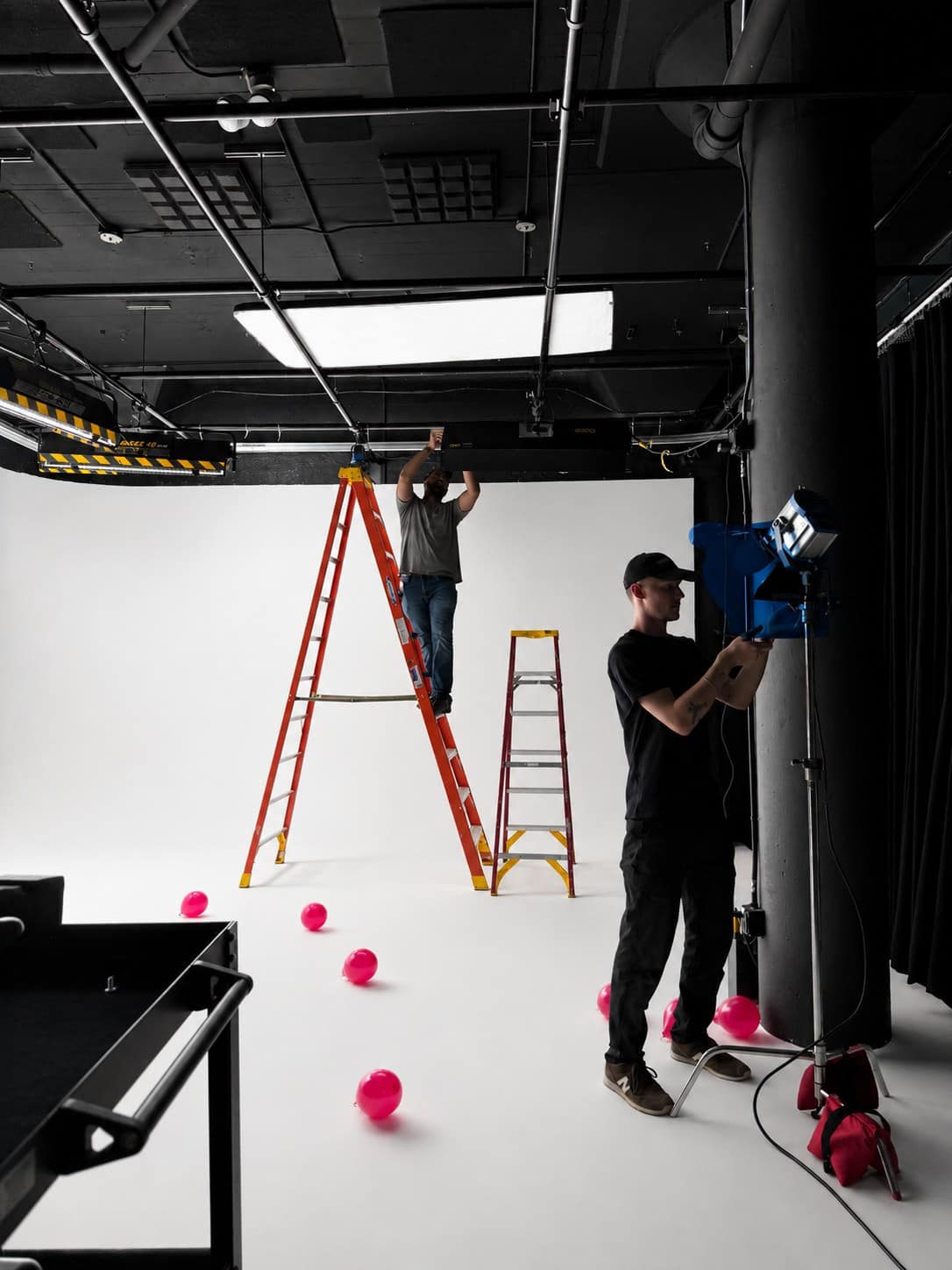 Video production crew setting lights inside VibeShack Studios