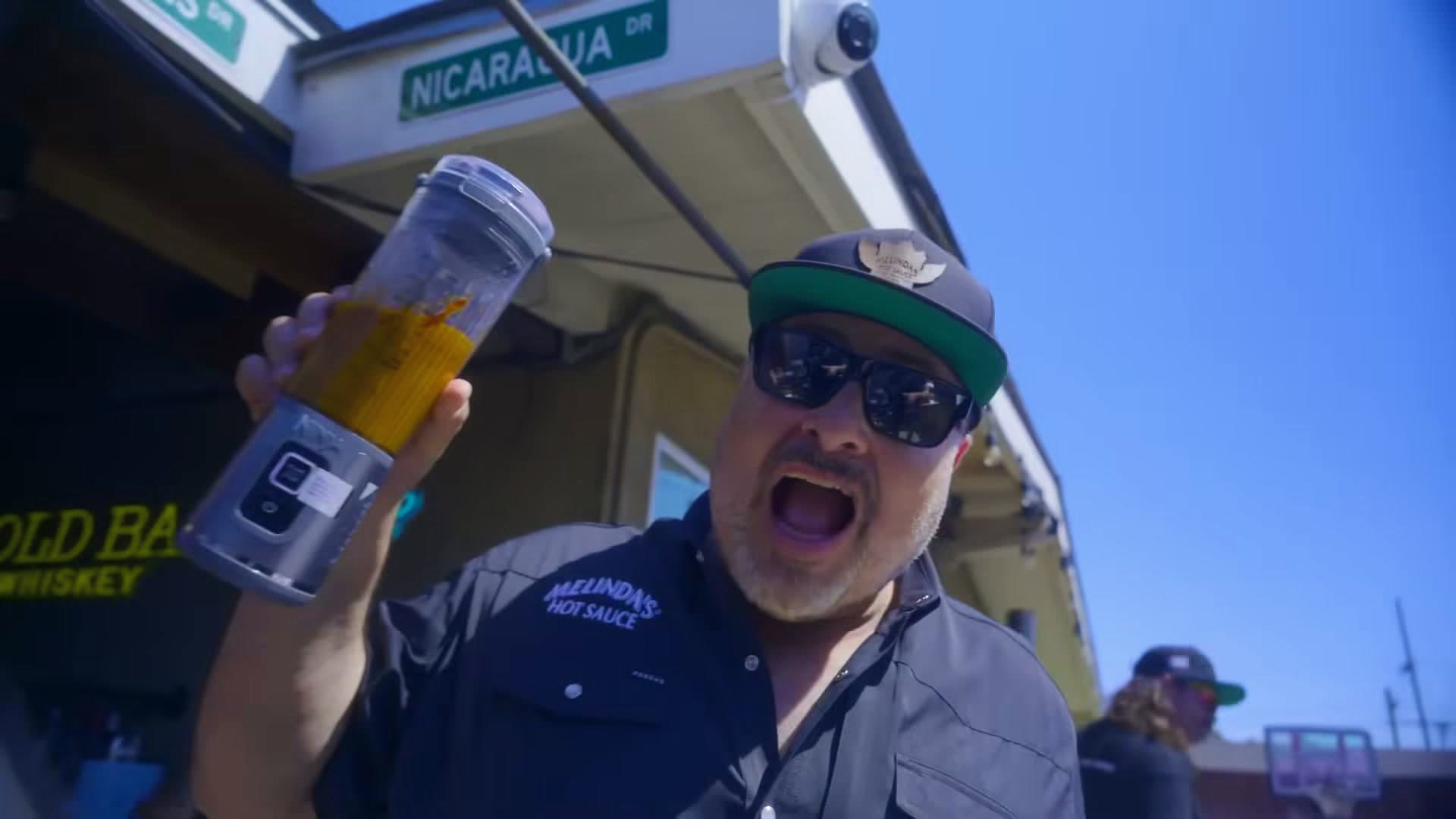 A competitor raises a drink outside the bar at Melinda's Wing Battle